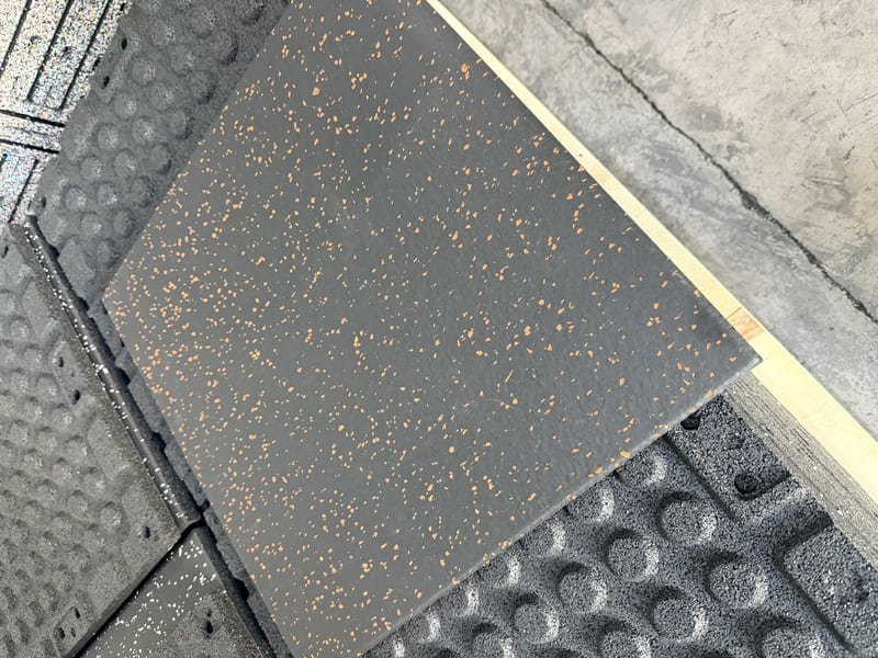 Gym members wiping down rubber floor mats after training